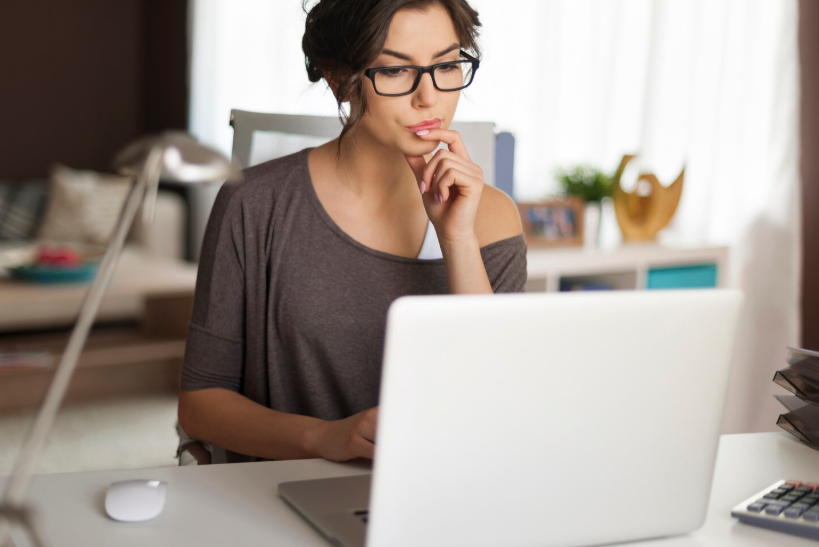 Woman thoughtfully researching online and reflecting on questions that never go out of style.