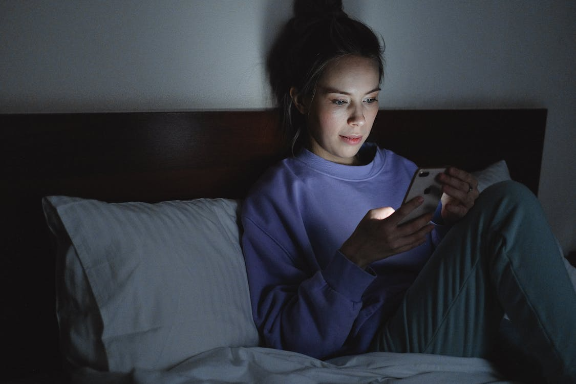 Late-night search behavior on a smartphone in a quiet bedroom.